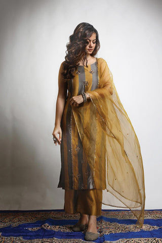 Featuring a straight Patchwork Kurta embroidered with intricately designed motifs. Paired with matching Wide legged Pants and an embroidered Dupatta.