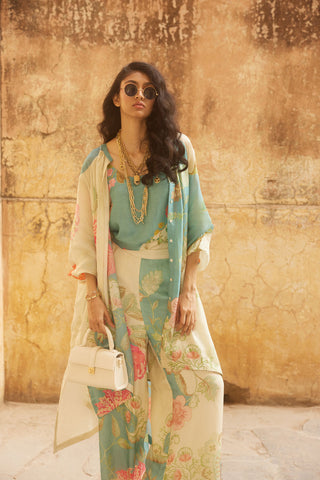 A floral placement co-ord set crafted from luxurious habutai silk. It features a beautiful floral placement relaxed kurta shirt embellished with shell buttons, straight cut pants with a printed cami and contrast colour printed scarf.