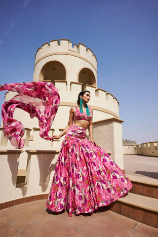 Fuchsia floral printed lehenga with embroidered bottom , paired with raw satin printed blouse embroidered all over and floral printed organza dupatta, with scallop embroidery on the edge.