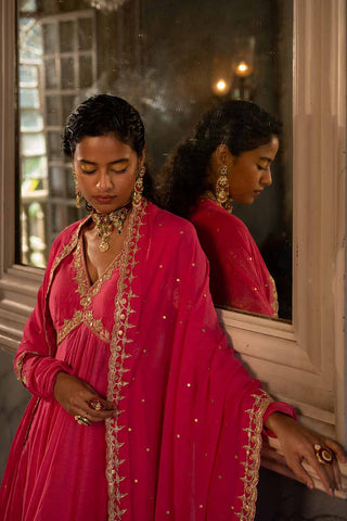 Hina Fuschia pink cotton silk anarkali set paired with an organza base dupatta with antique gold dori and embellished with sequin hand–embroidery.