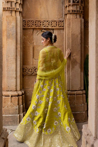 Model posing to show the back of the wedding dress