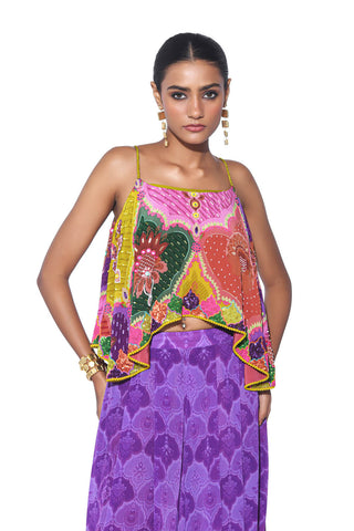 Close up look of multi color embroidered crop top with violet
print pleated palazzo.