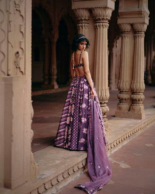 Model posing to show the back of the lehenga