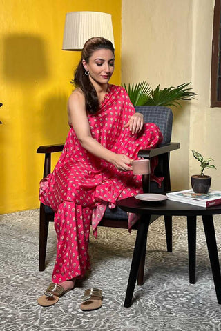 Soha Ali Khan showcases effortless elegance in Paulmi and Harsh beautiful butti printed one shoulder dress in rani pink, with small bell detailing on the neck and is paired with same print palazzos.