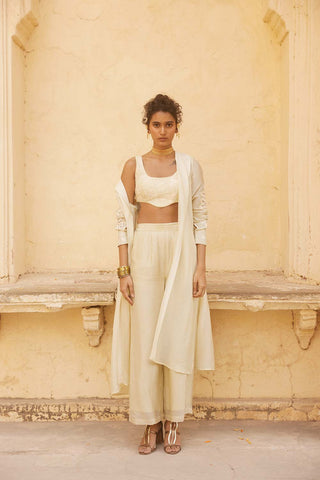 A jacket set in silk organza fabric in Ivory colour. It is a set of crop top (blouse), trouser and jacket.