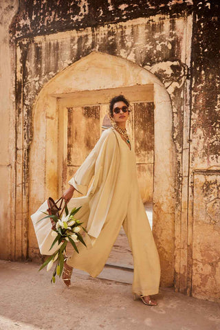 Indo Western Jumpsuit in an ivory silk linen fabric with jacket designed by Paulmi and Harsh. A perfect dress for a day out with family and friends, casual wear, picnic, beach or a office wear.