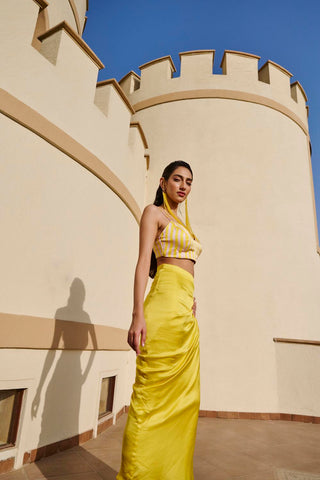 Model posing in Yellow striped crop top with pre-draped skirt.